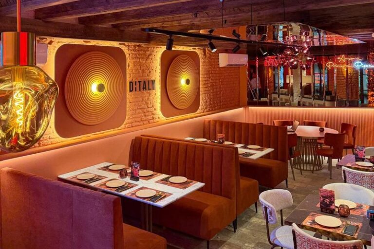 Rincón para comer auténtica pizza napolitana en Ditaly, con el neón "Amor a primera pizza" y luces circulares de diseño